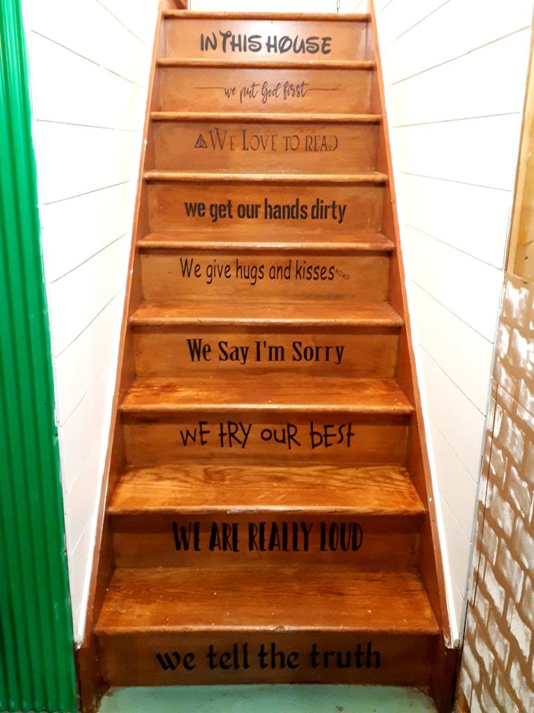 This image has an empty alt attribute; its file name is diy-faux-shiplap-stair-decal-in-this-family.jpg